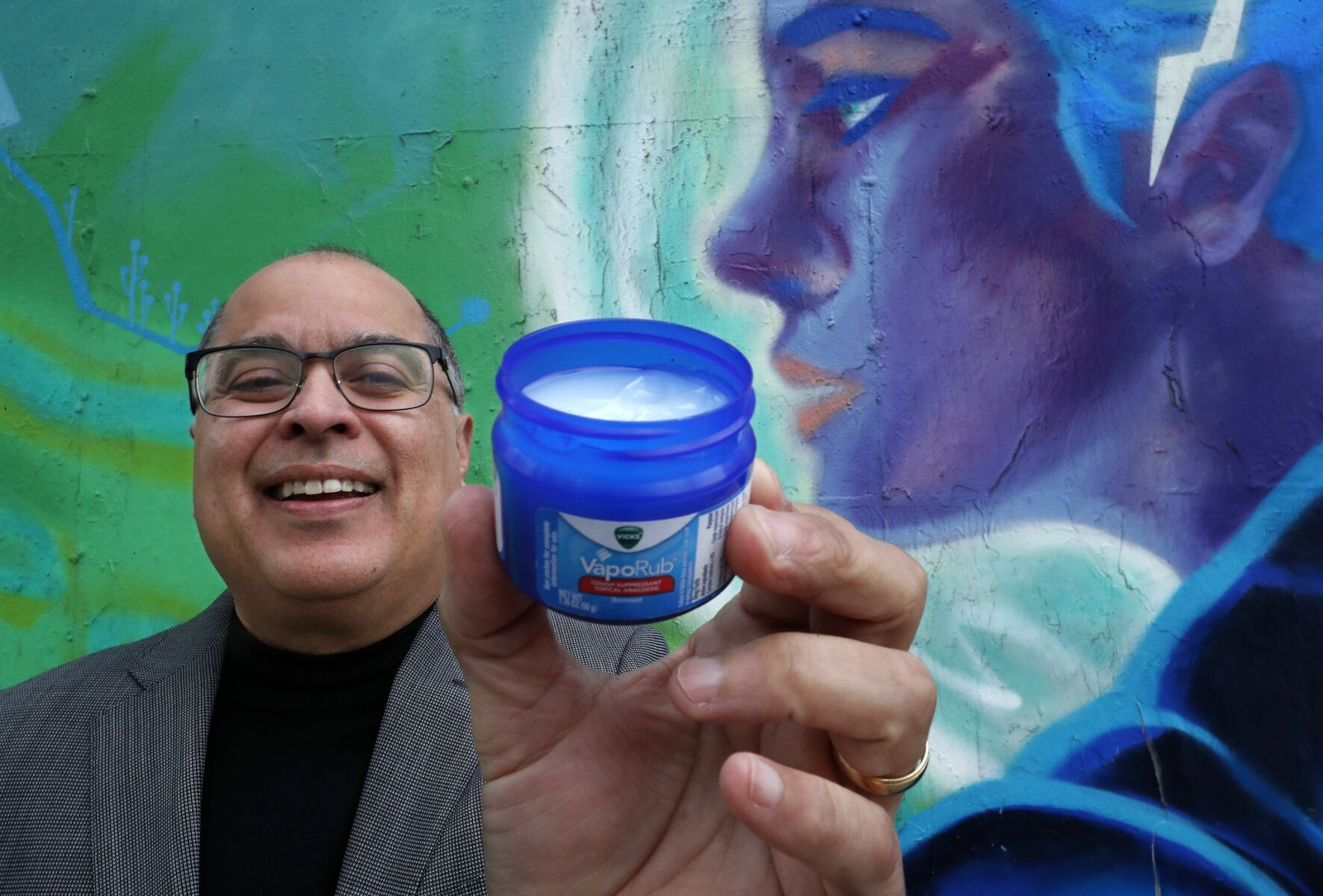 Writer Daniel Olivas,59, holds a jar of Vicks VapoRub near his office in downtown Los Angeles on December 14, 2018. 